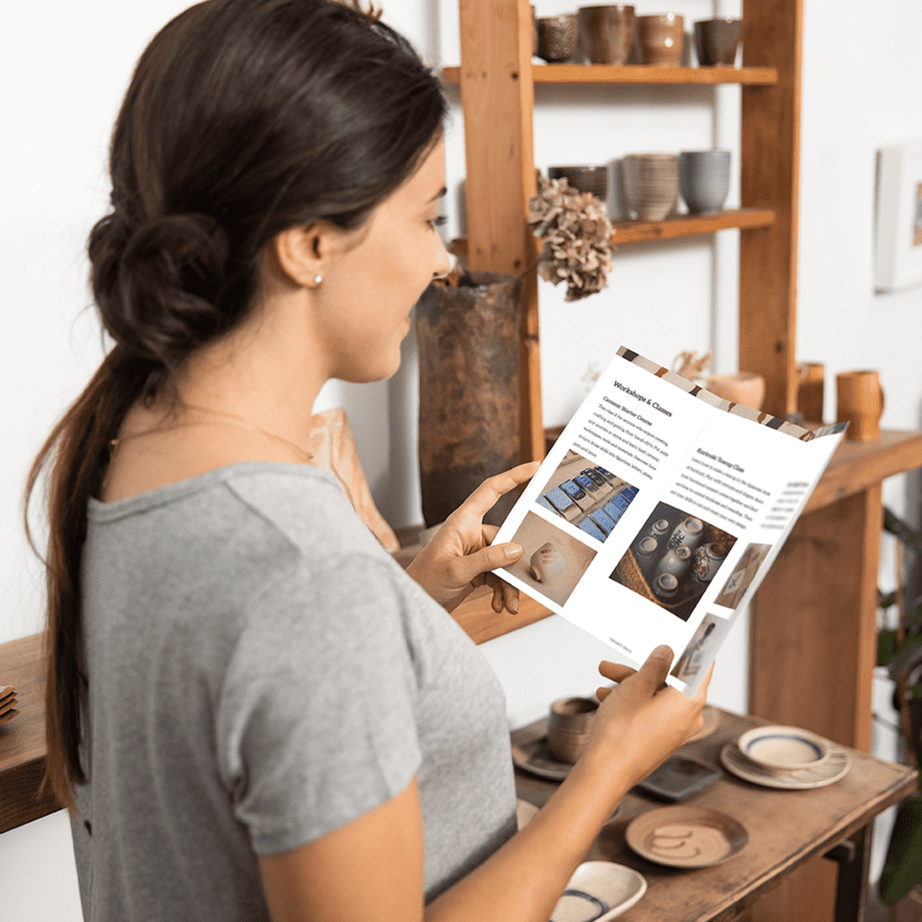 Target audience woman holding a business brochure.