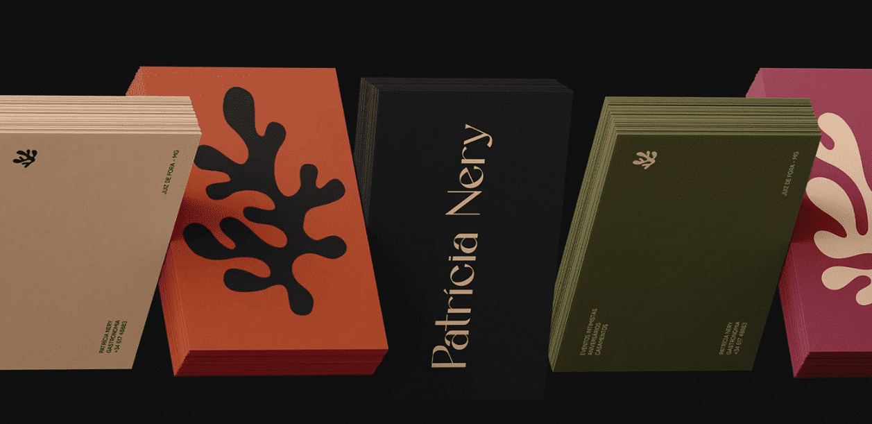 Set of different colored business cards in warm tones of orange, green, black and pink