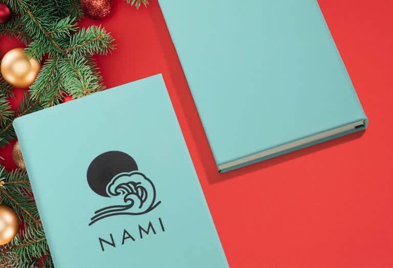 Blue notebook with black text and branded graphic.