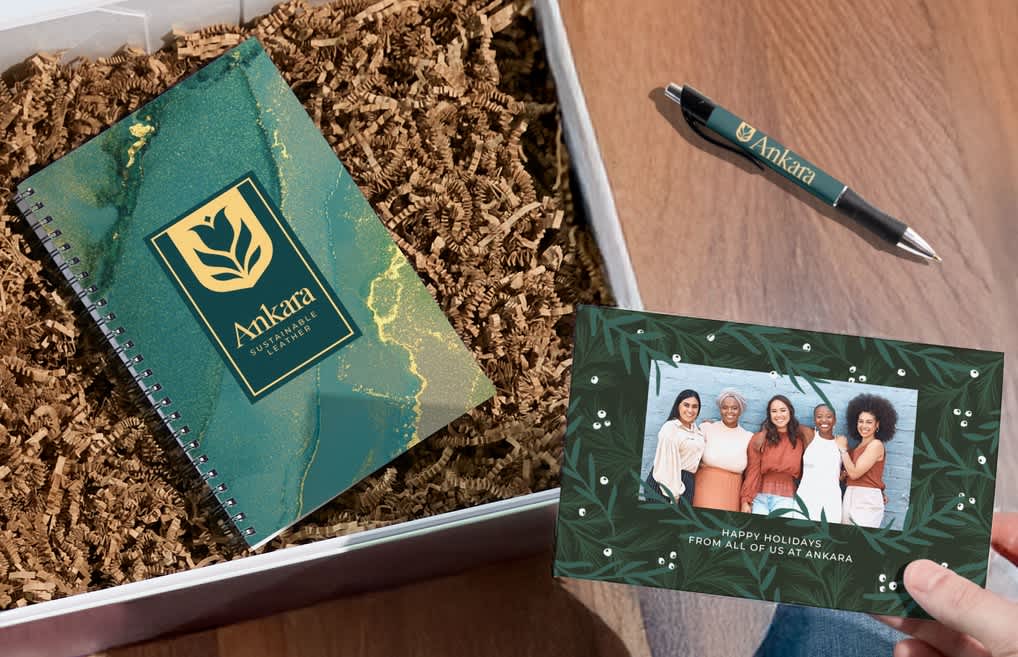 A notebook in a box with shredded filler and a personalized note from the brand.