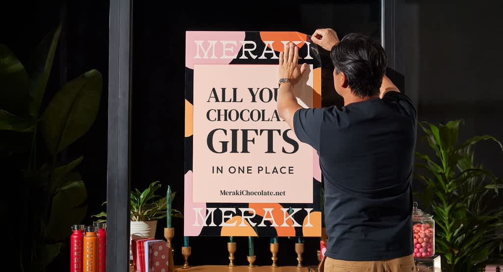 Window decal promoting holiday sale on gift boxes.