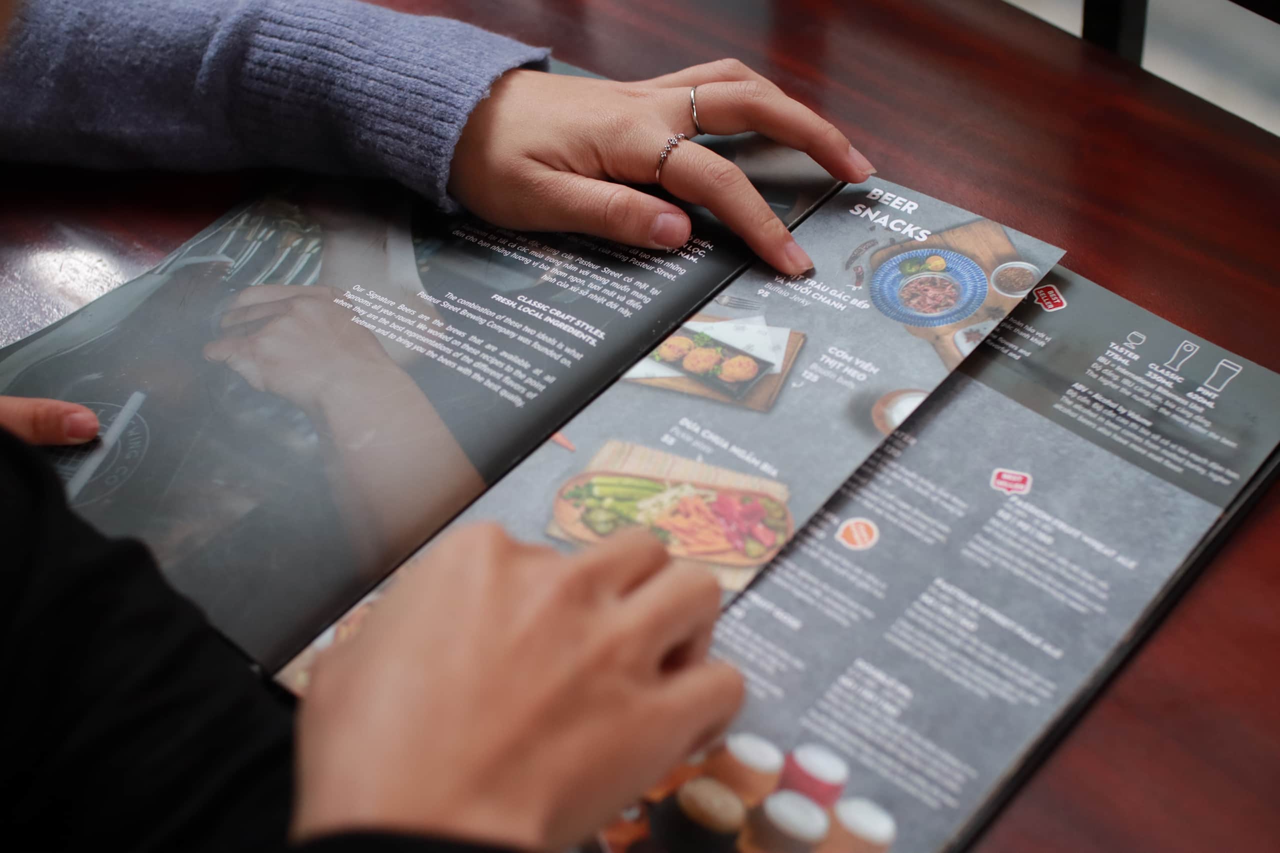 Close-up of a takeaway menu with a person’s hands in shot.
